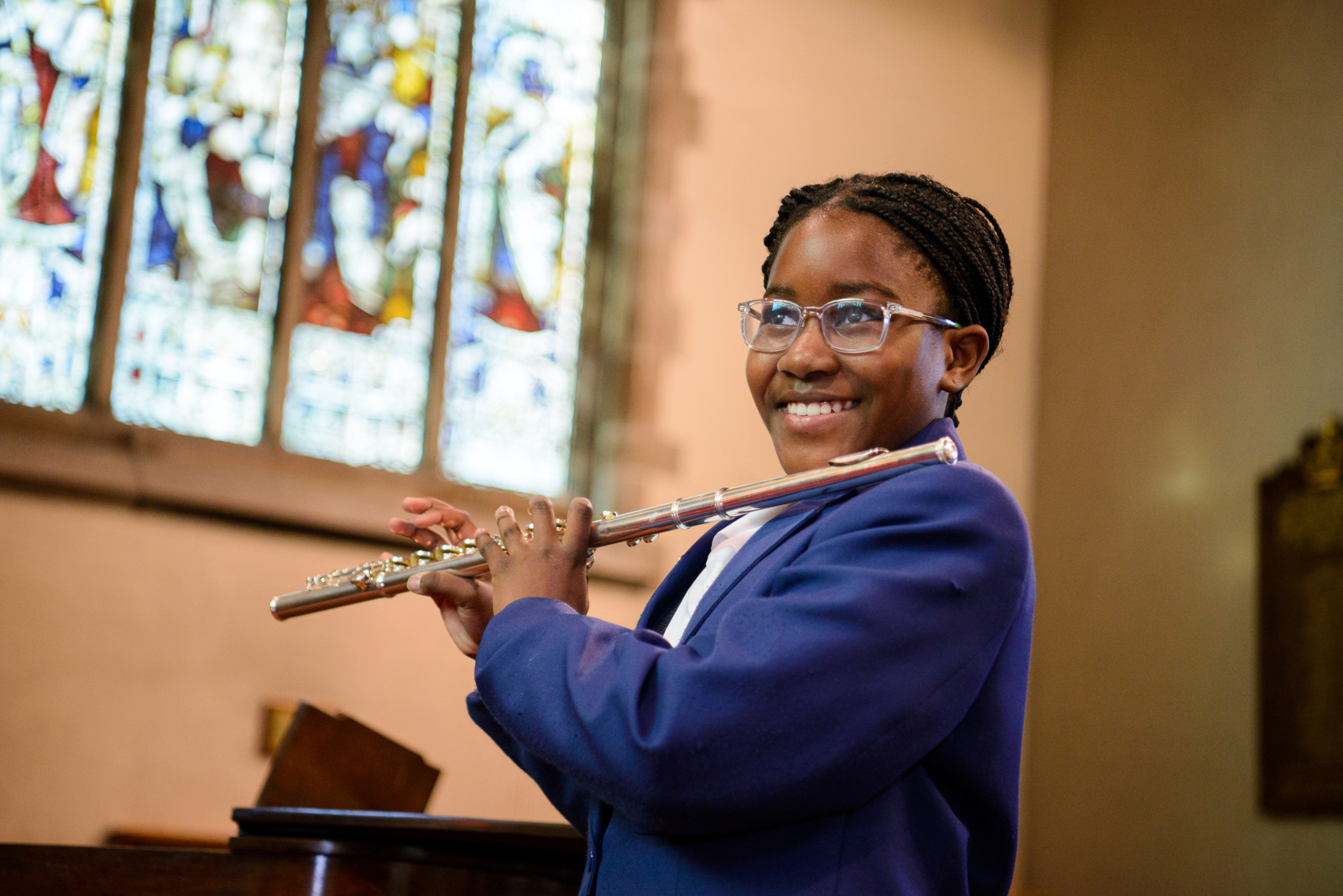 pupil playing the flute at a performing arts concert